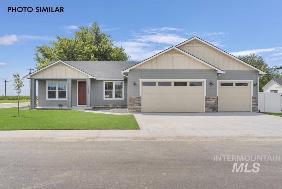 View of front of home featuring a garage, a front yard, driveway, board and batten siding, and covered porch