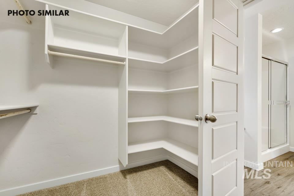 Spacious closet featuring light wood-style flooring