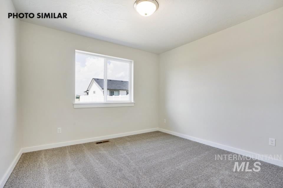 Unfurnished room featuring light colored carpet and baseboards