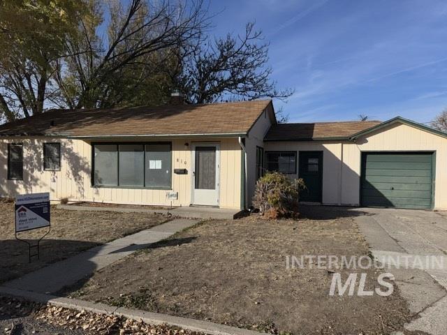 Single story home featuring driveway, a garage, and a shingled roof