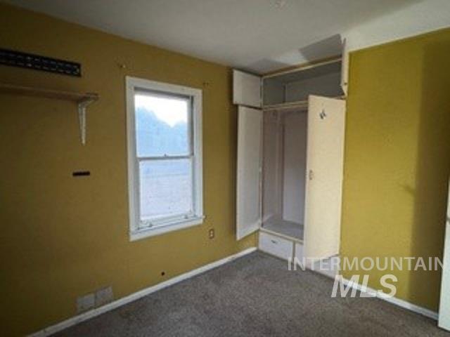 Unfurnished bedroom with a closet and carpet flooring