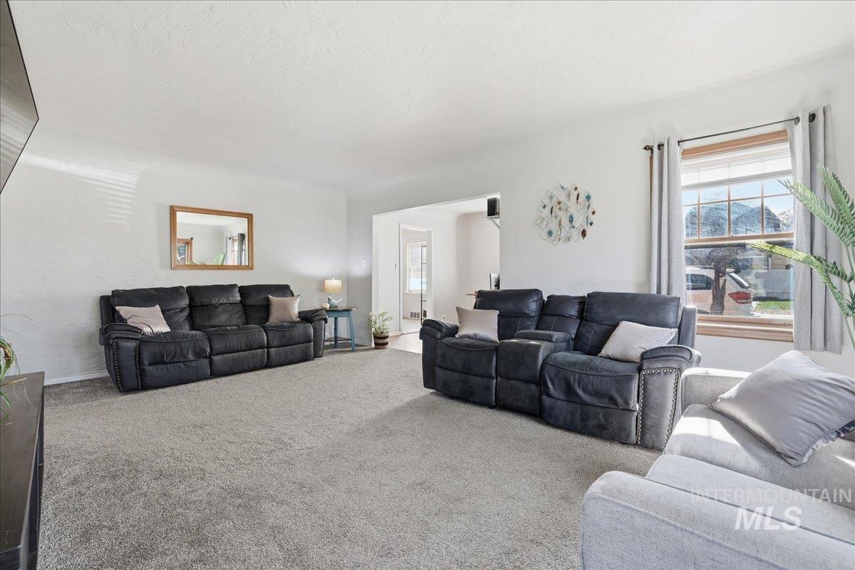 Carpeted living area with baseboards