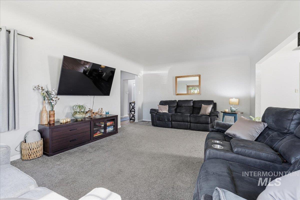 Living area featuring carpet and baseboards