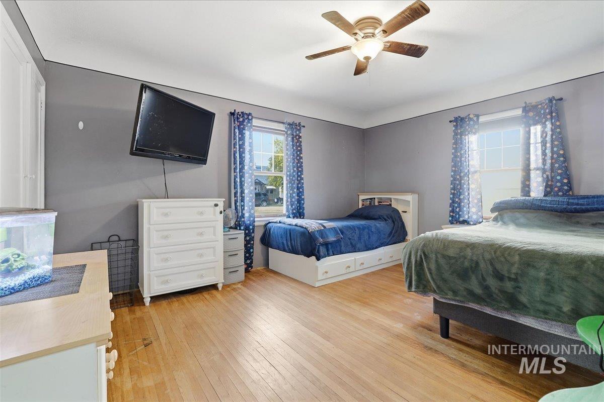 Bedroom with light wood finished floors and ceiling fan