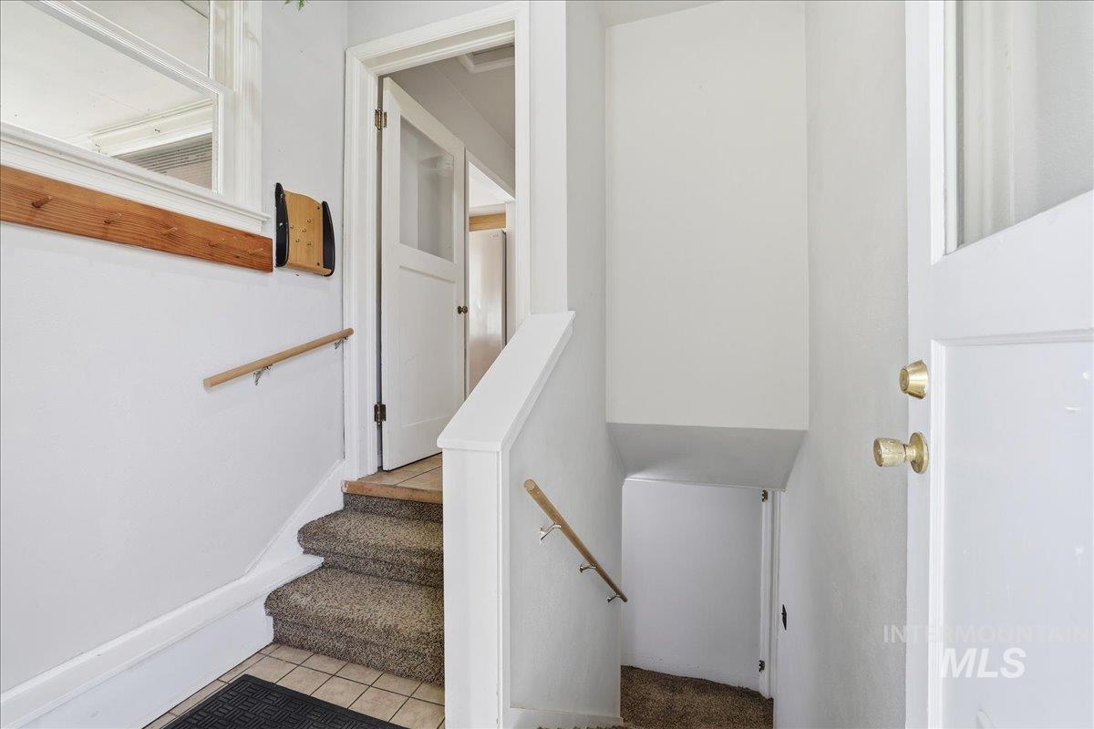 Stairs featuring tile patterned flooring