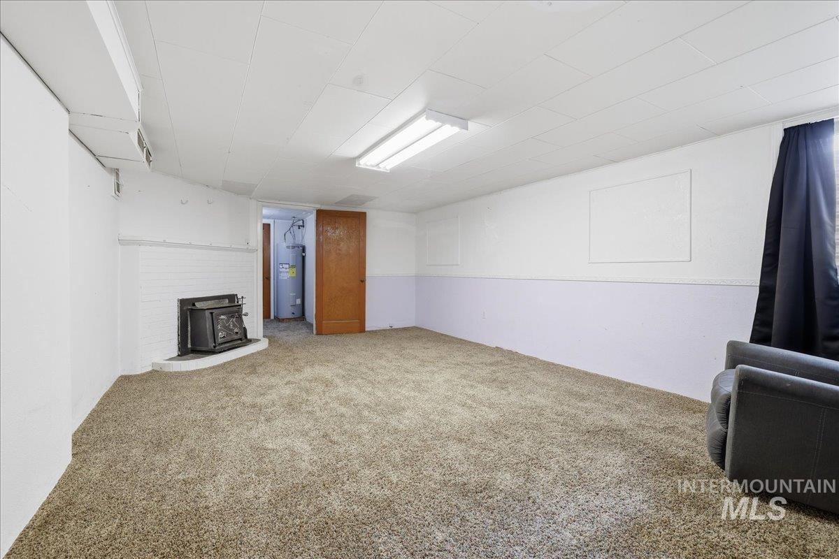 Finished basement featuring carpet floors and water heater