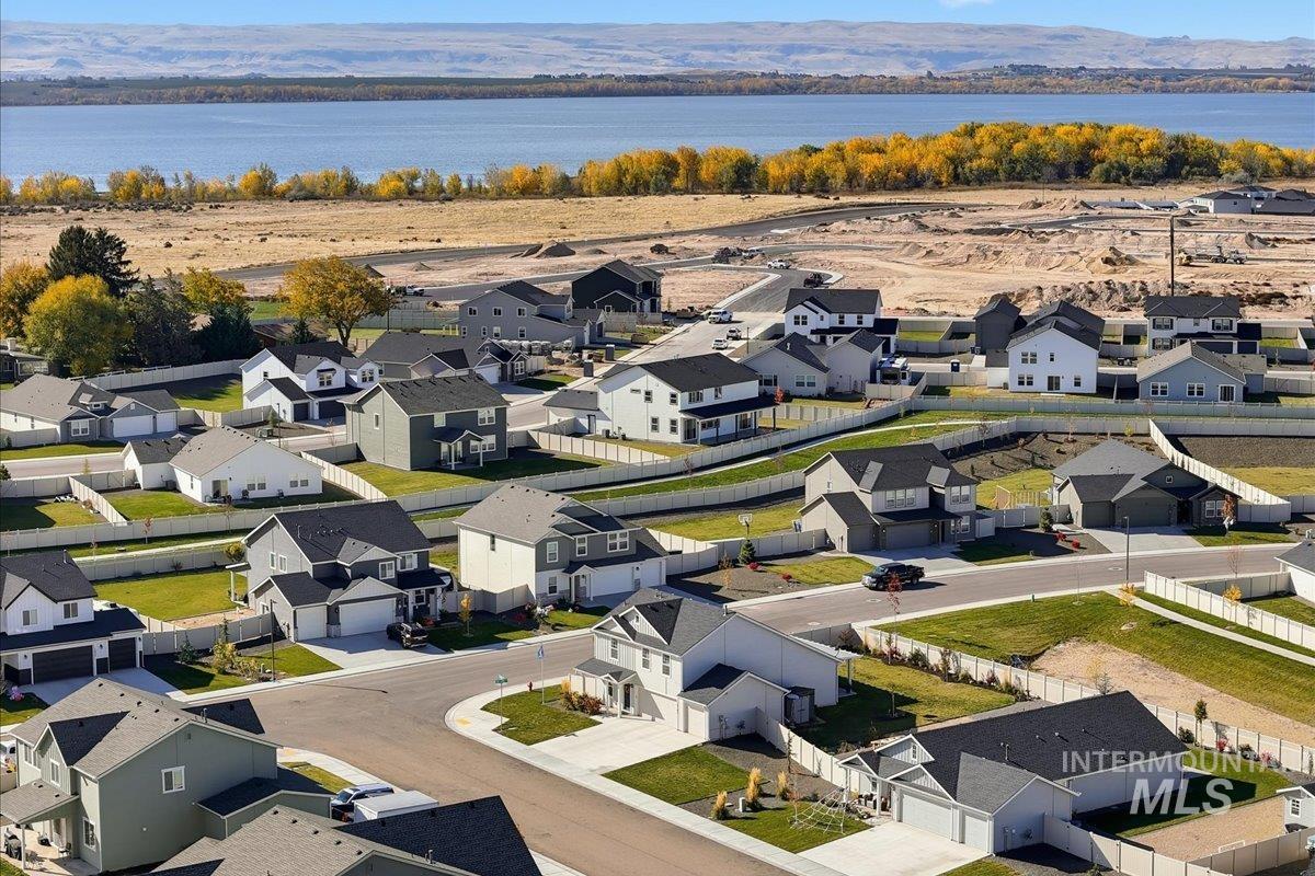 Aerial perspective of suburban area with a water and mountain view