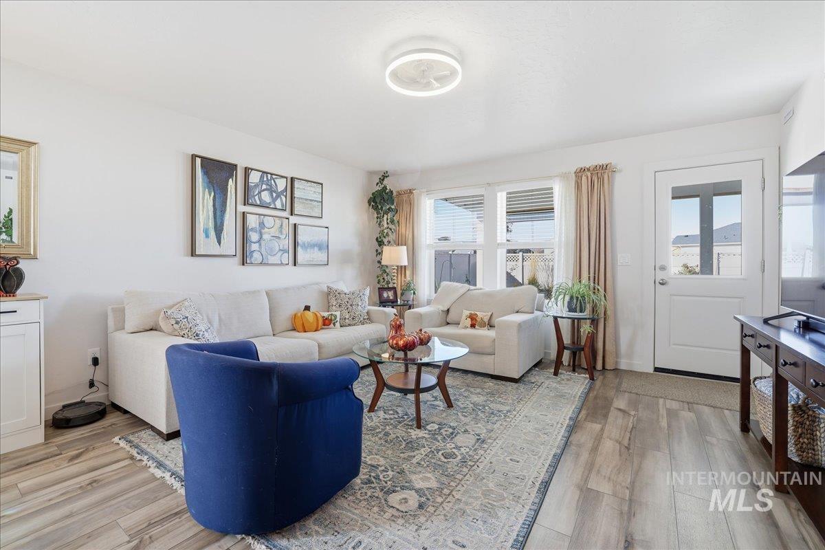 Living area with plenty of natural light and light wood-type flooring