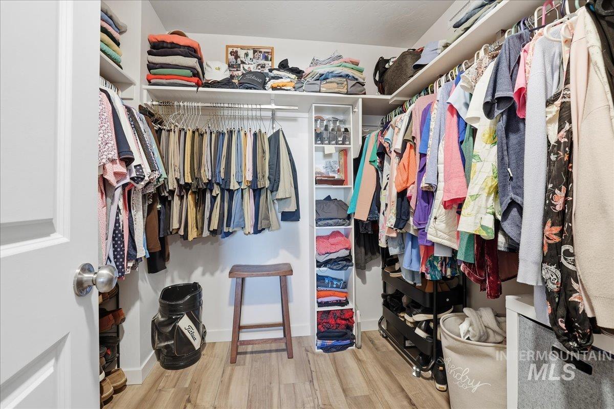 Walk in closet featuring light wood-style floors
