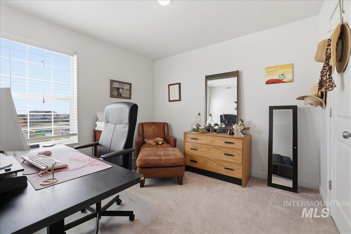 Office space with light carpet and baseboards