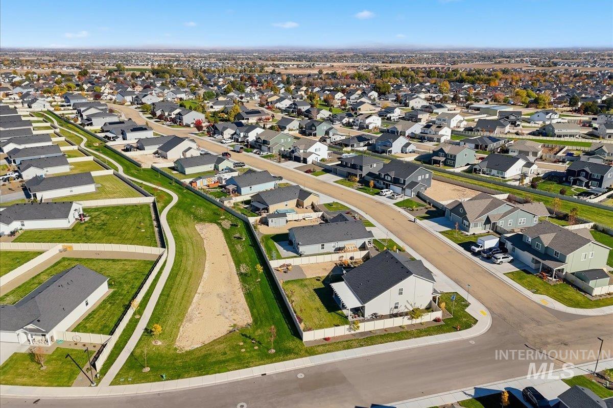Aerial view of property and surrounding area with nearby suburban area