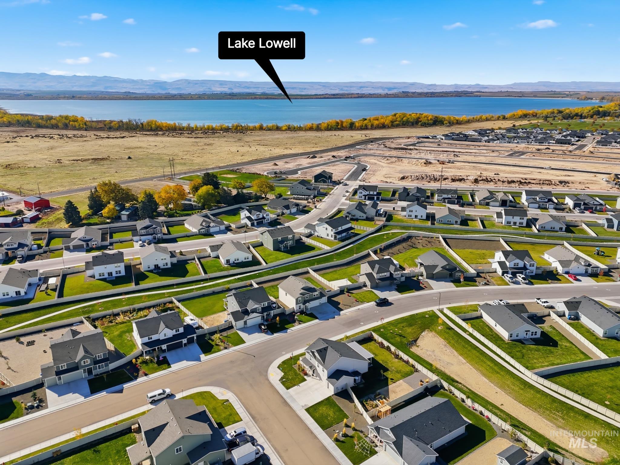 Aerial view of residential area featuring a water and mountain view