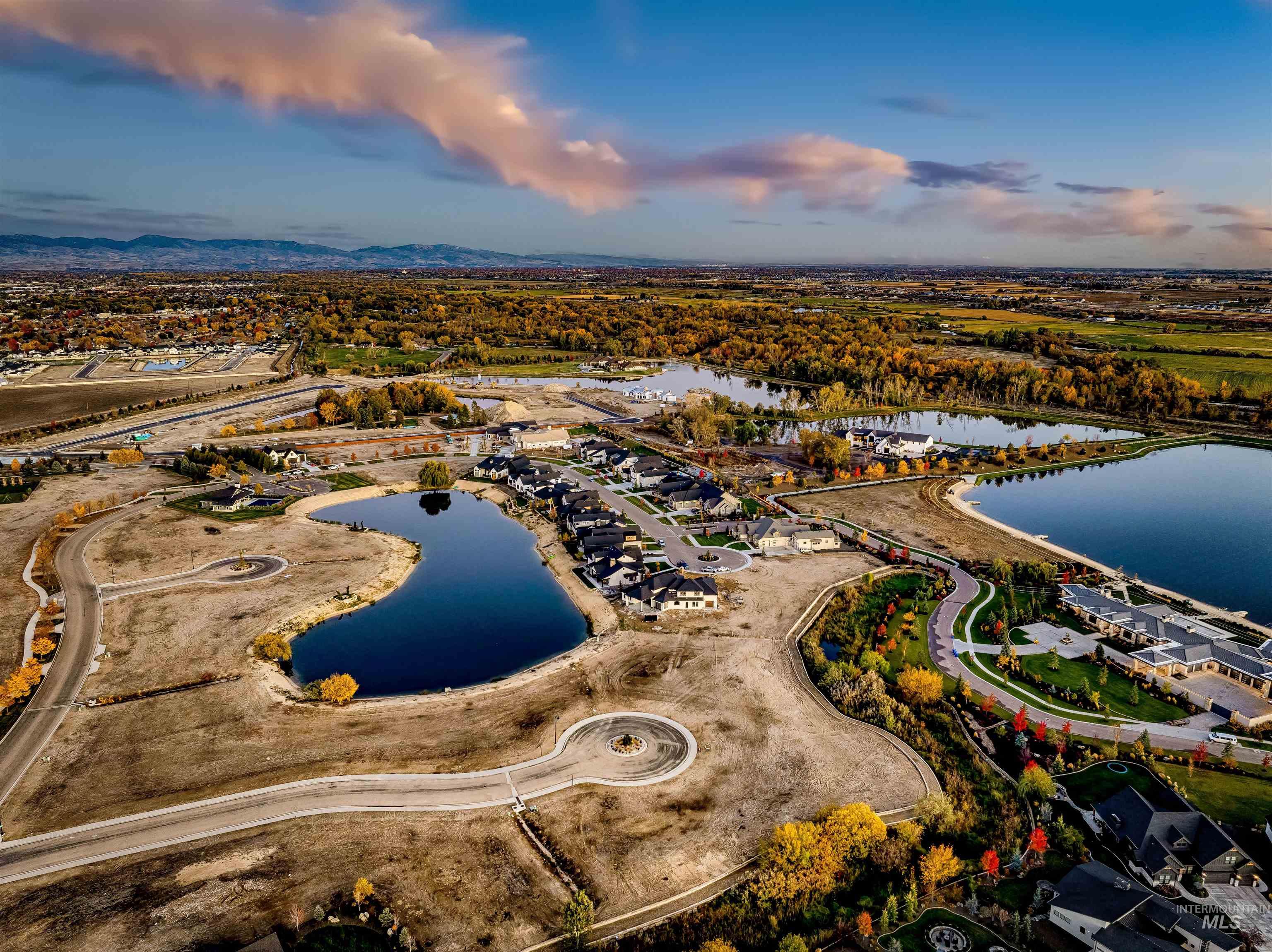 Aerial view of property and surrounding area with a large body of water and nearby suburban area