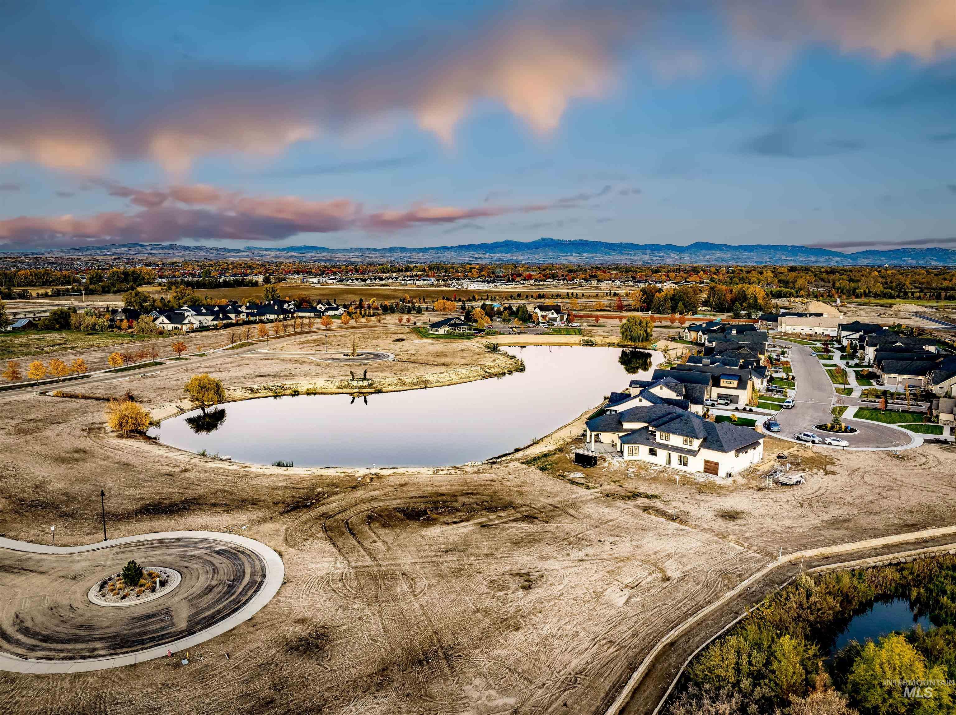 Aerial view of residential area featuring a water and mountain view