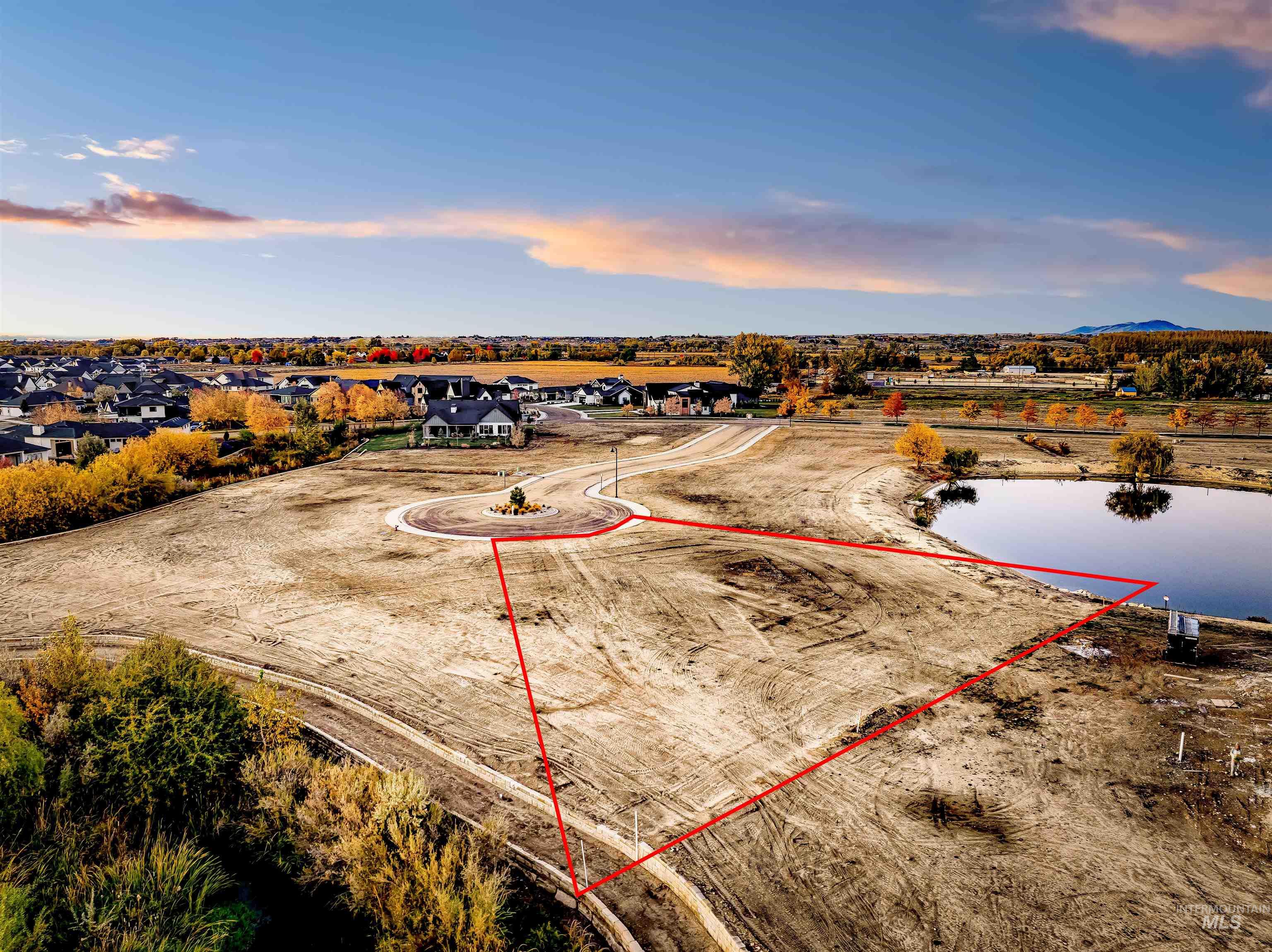 Aerial view at dusk of property boundaries highlighted and a water view