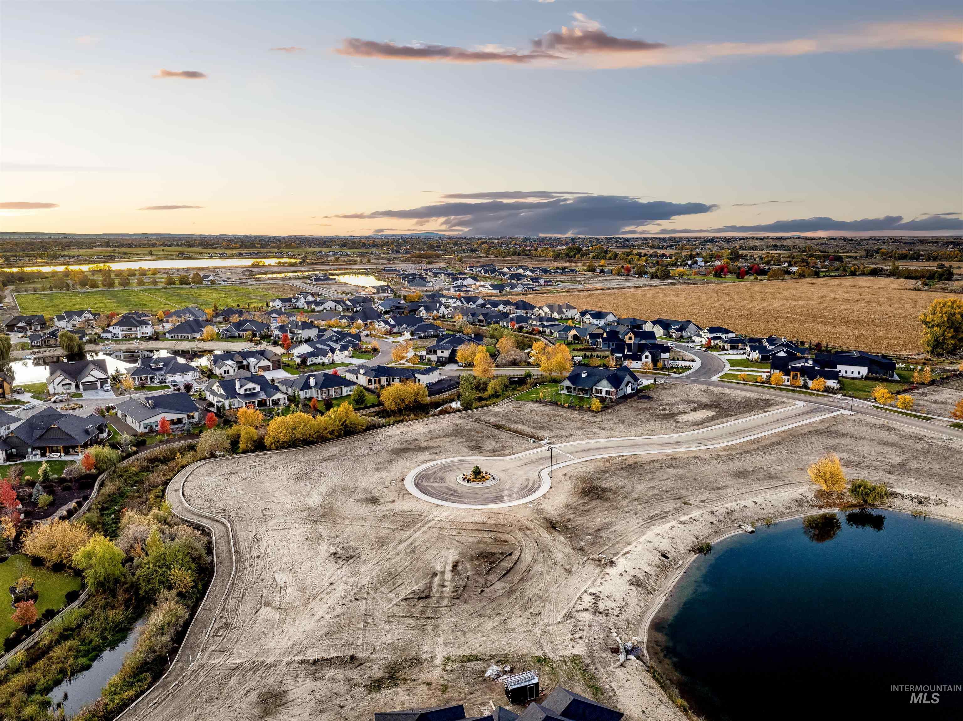 Aerial view at dusk of a water view and a residential view