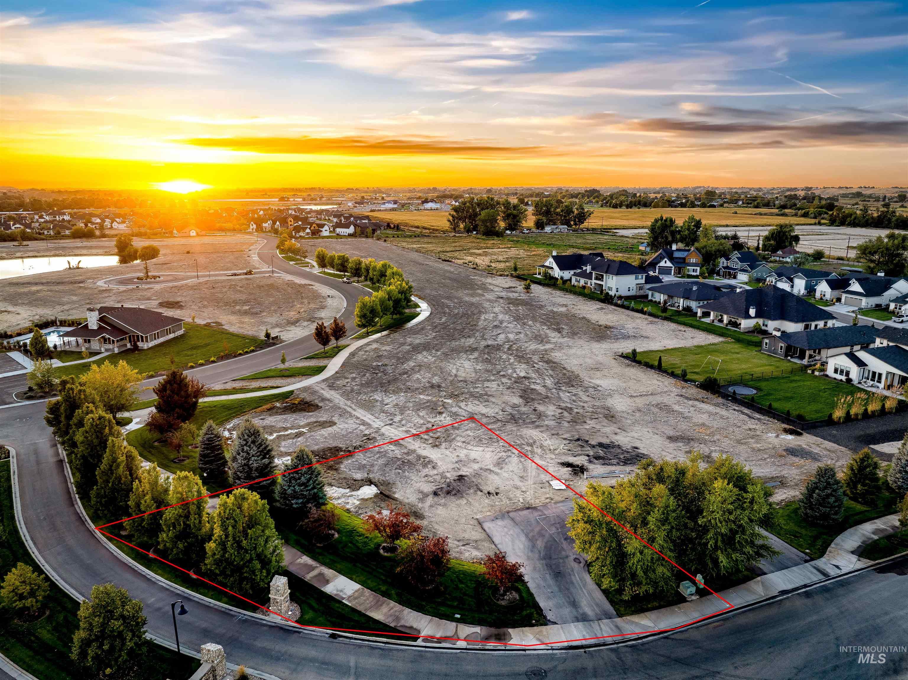 Aerial view at dusk of a residential view and property parcel outlined