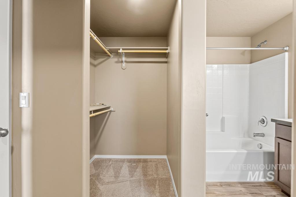 Spacious closet featuring light wood-type flooring