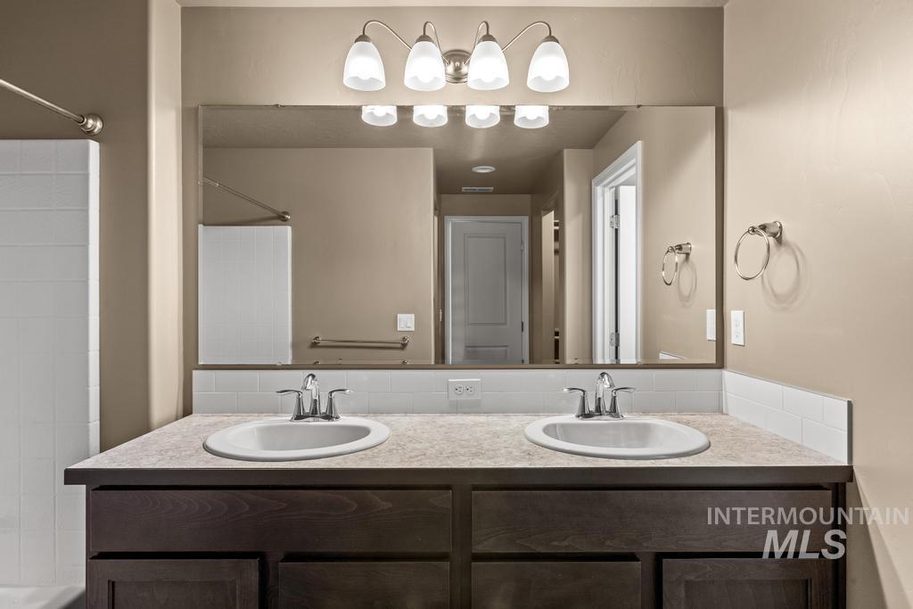 Full bath featuring double vanity