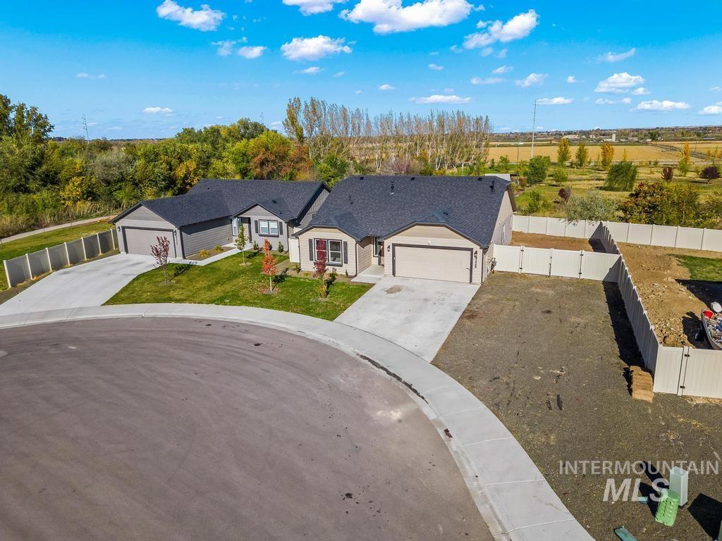 View of front of home featuring a gate and driveway