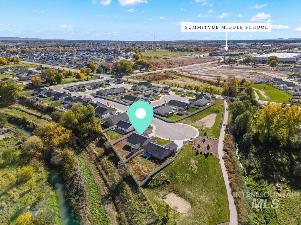 Aerial overview of property's location featuring nearby suburban area