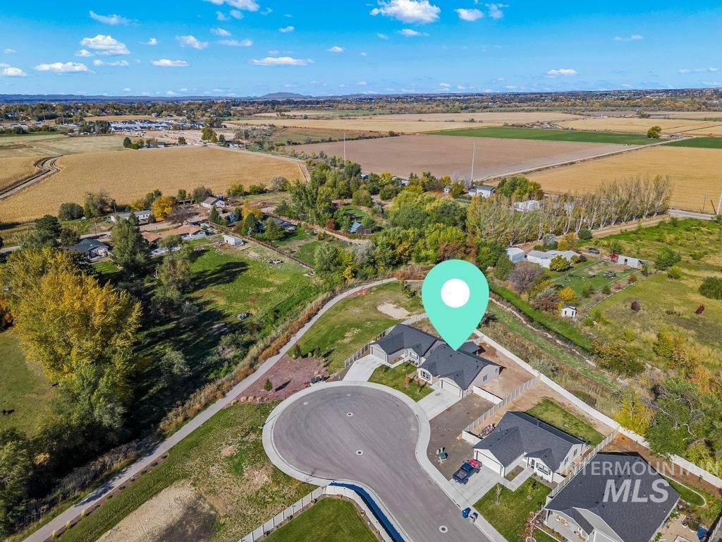 Aerial view of property and surrounding area featuring nearby suburban area