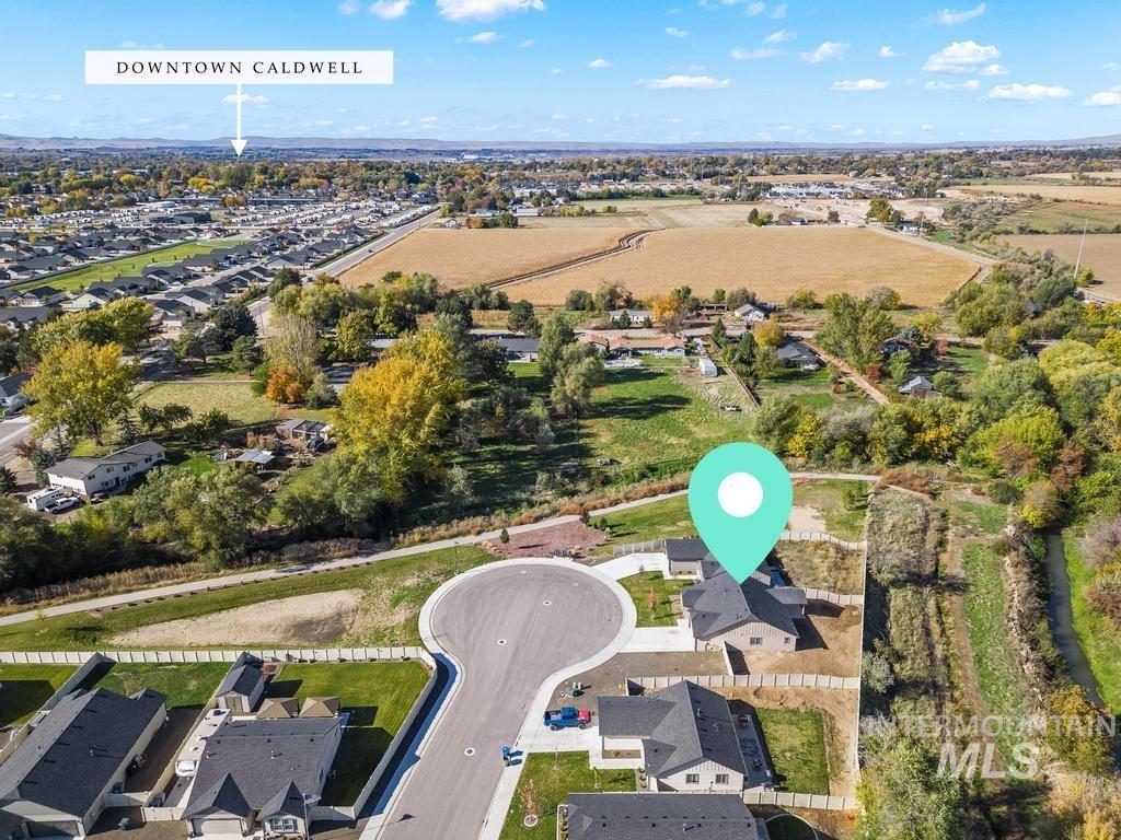 Aerial view of property's location with nearby suburban area