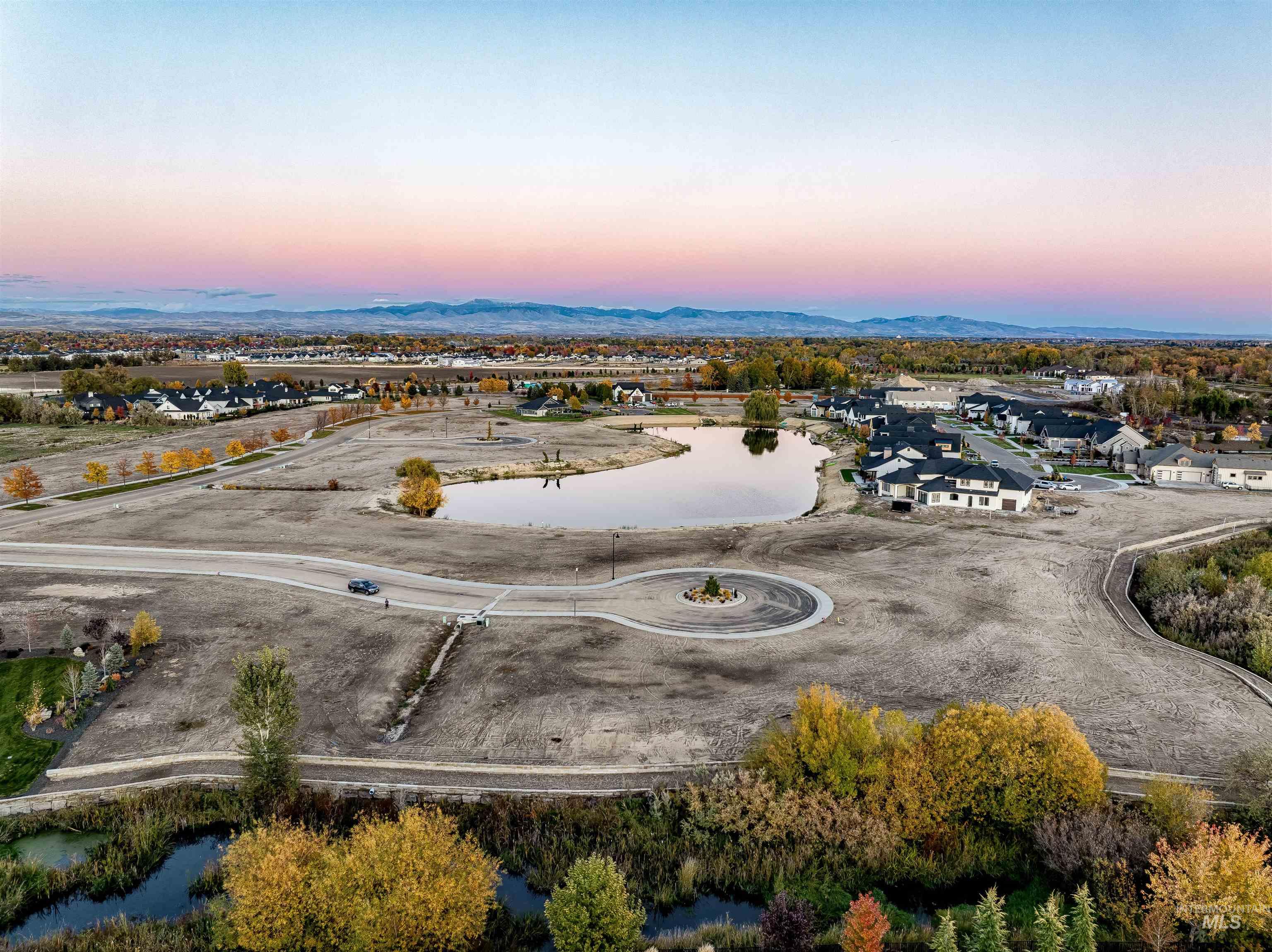 Aerial view at dusk of a water and mountain view and a residential view