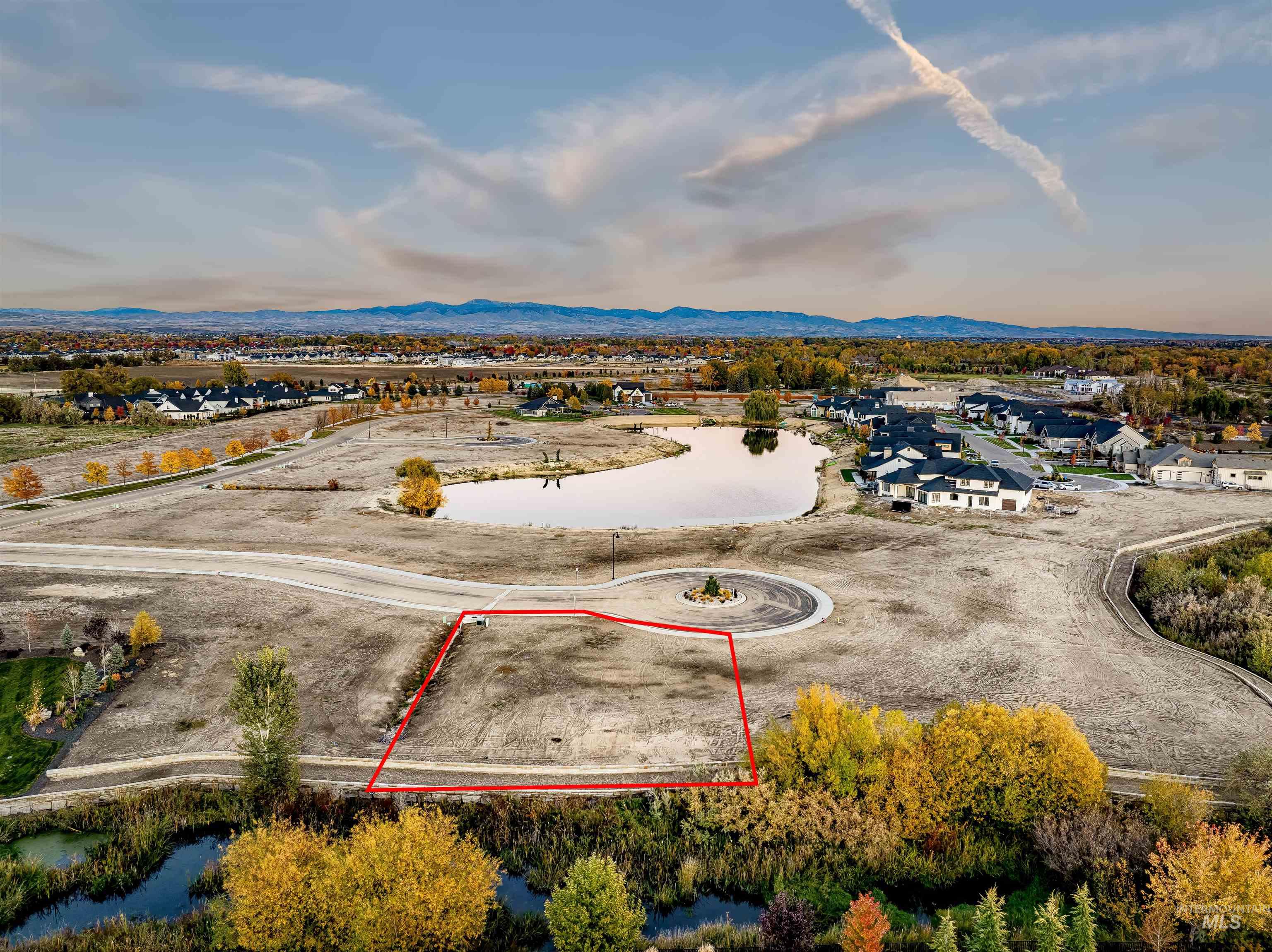 Aerial view of residential area featuring property parcel outlined and a mountainous background