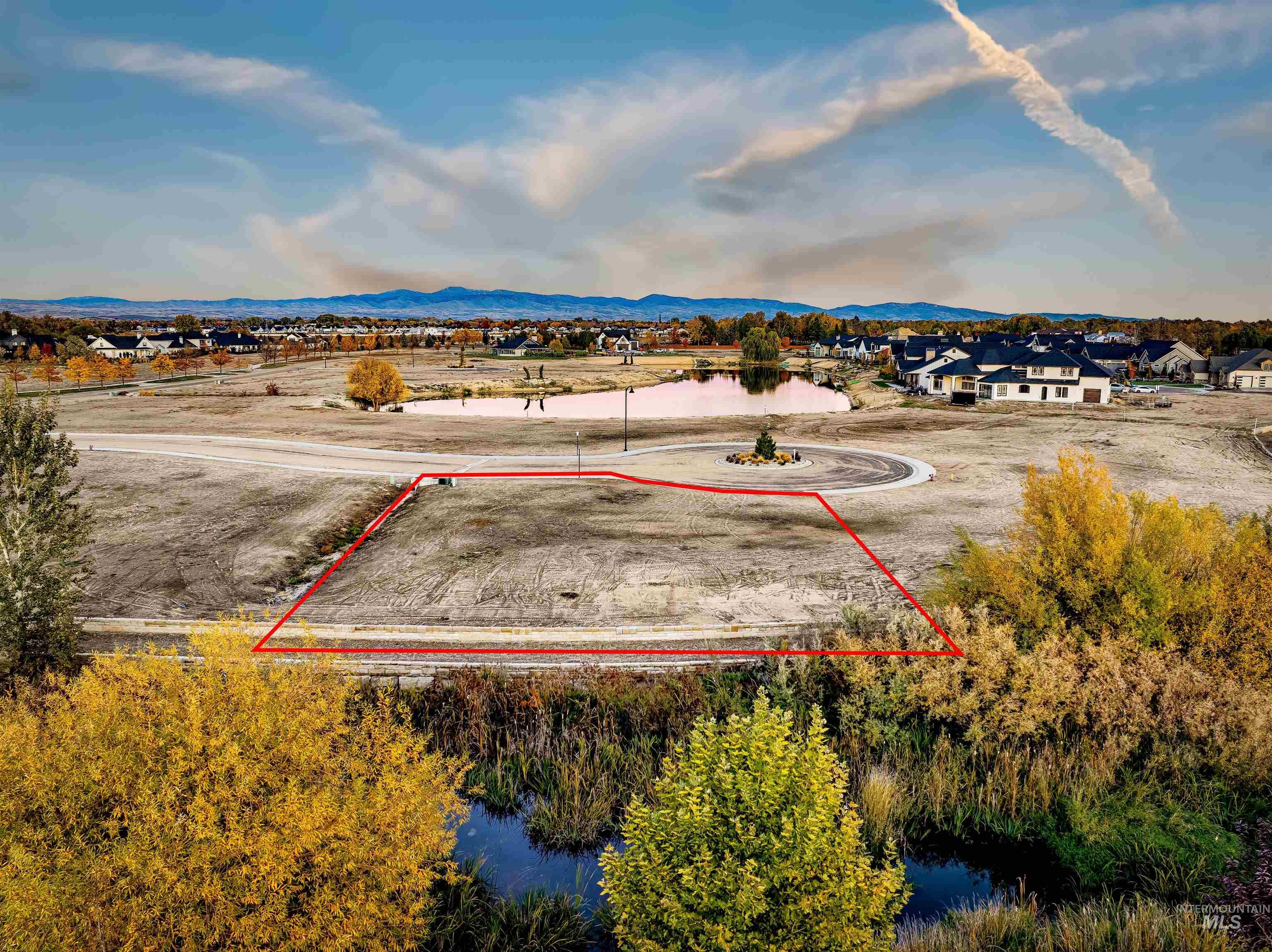 Aerial view of property's location with property parcel outlined and a water and mountain view