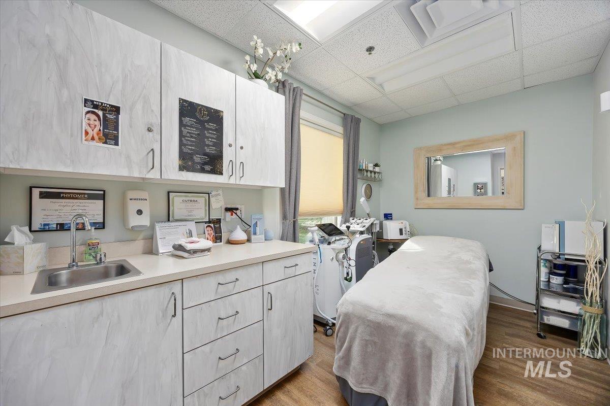 Washroom featuring a drop ceiling and light wood-type flooring