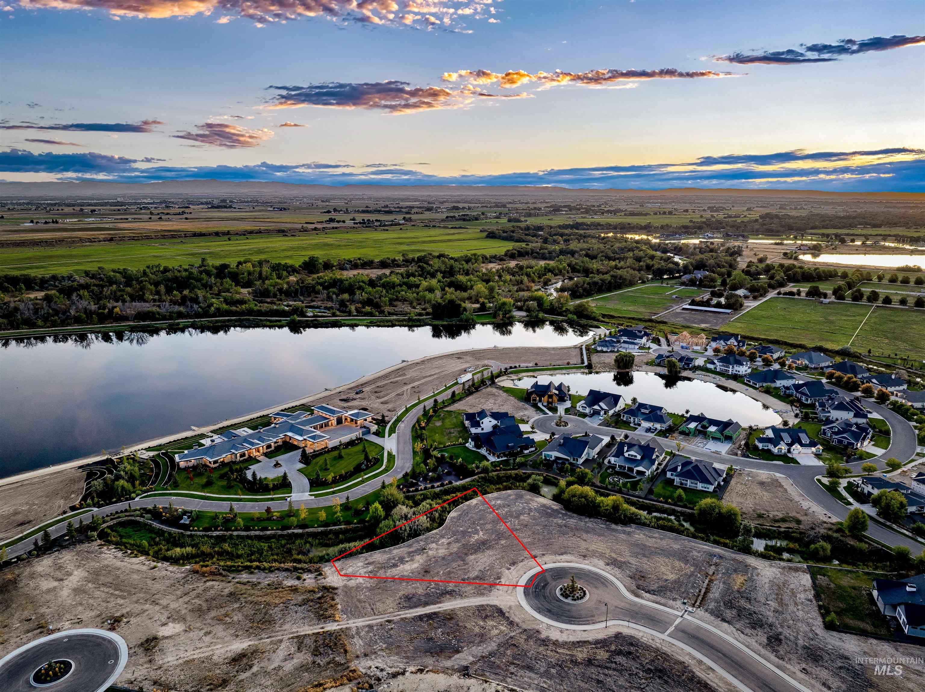 Aerial view of residential area featuring a large body of water and property boundaries highlighted