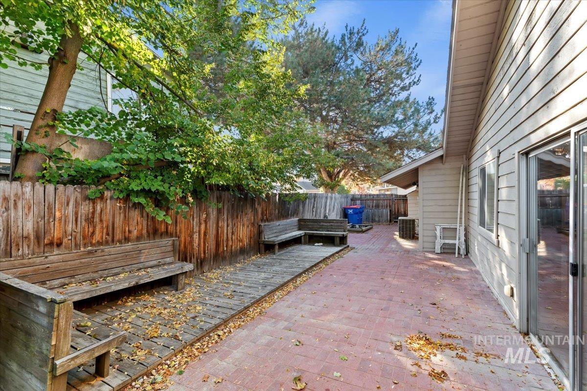 Fenced backyard with a patio and a deck