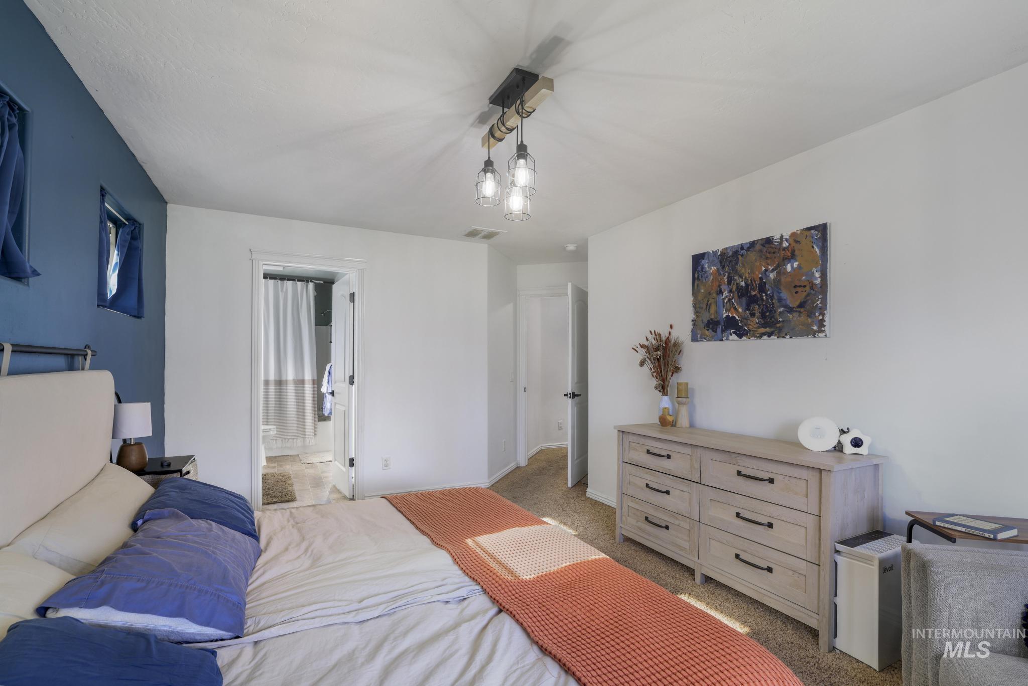 Bedroom featuring carpet and ensuite bath