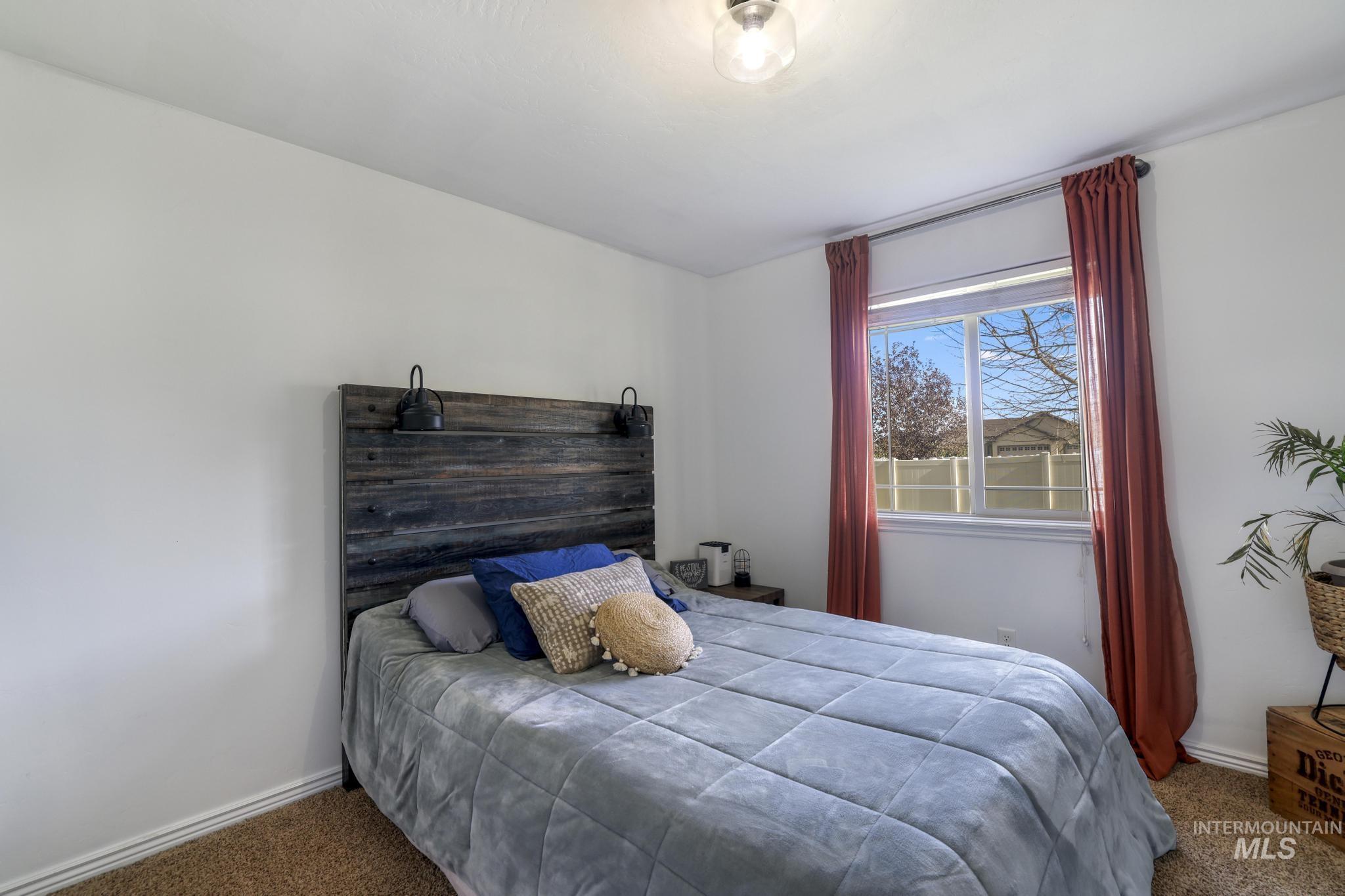 Carpeted bedroom featuring baseboards