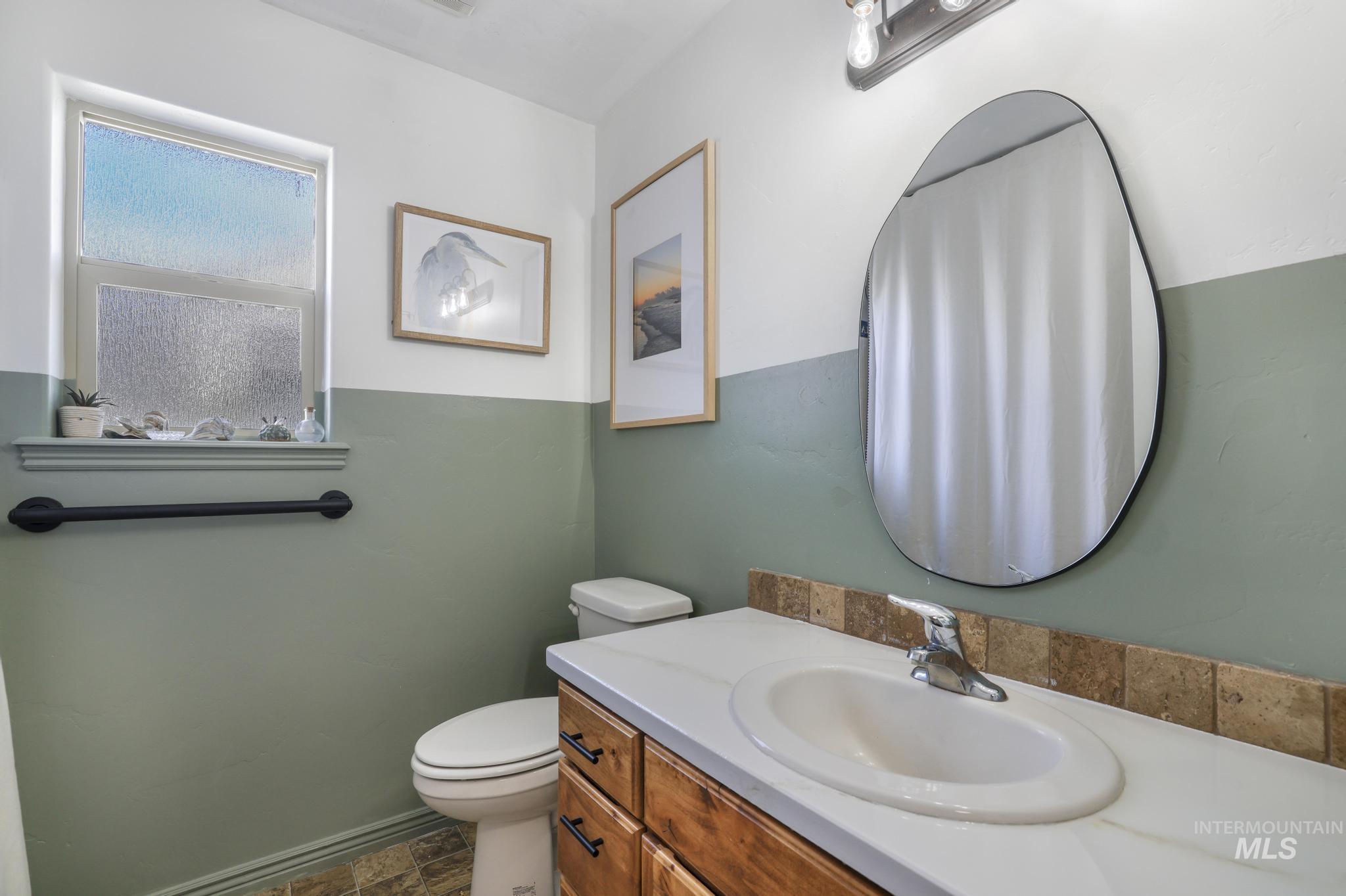 Bathroom featuring a shower with shower curtain and vanity