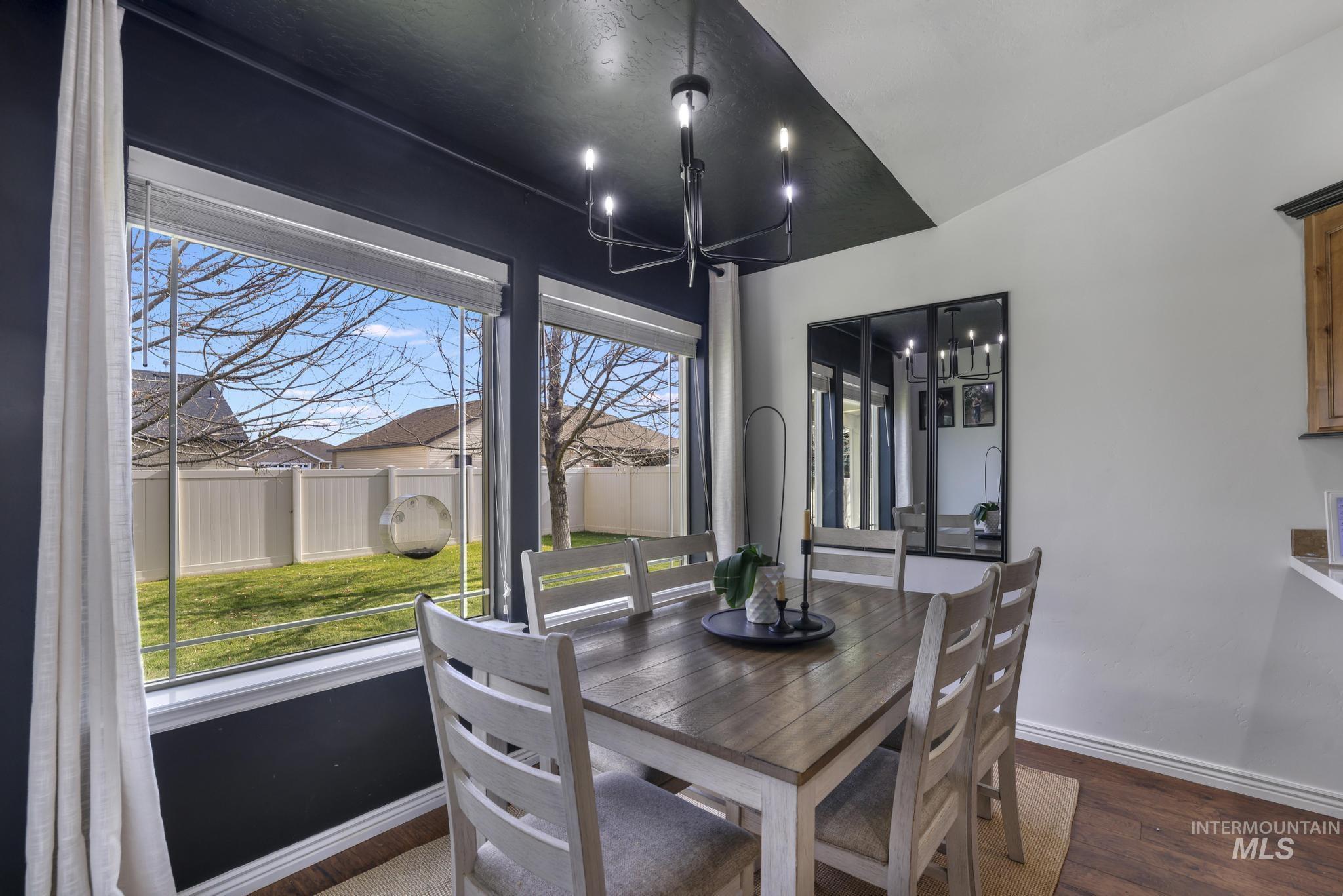Dining room featuring dark wood-type flooring and a chandelier