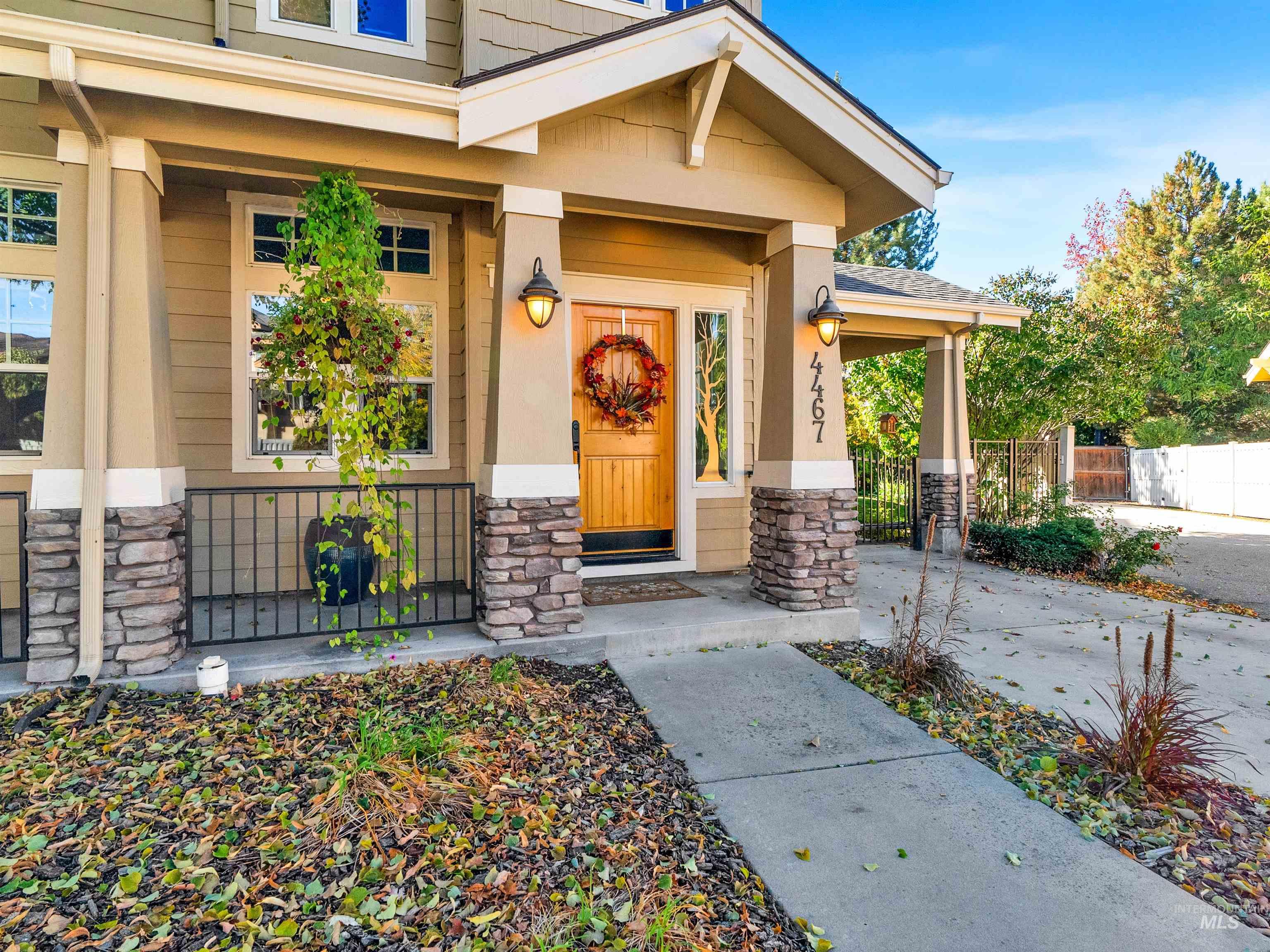 Property entrance with stone siding and a porch
