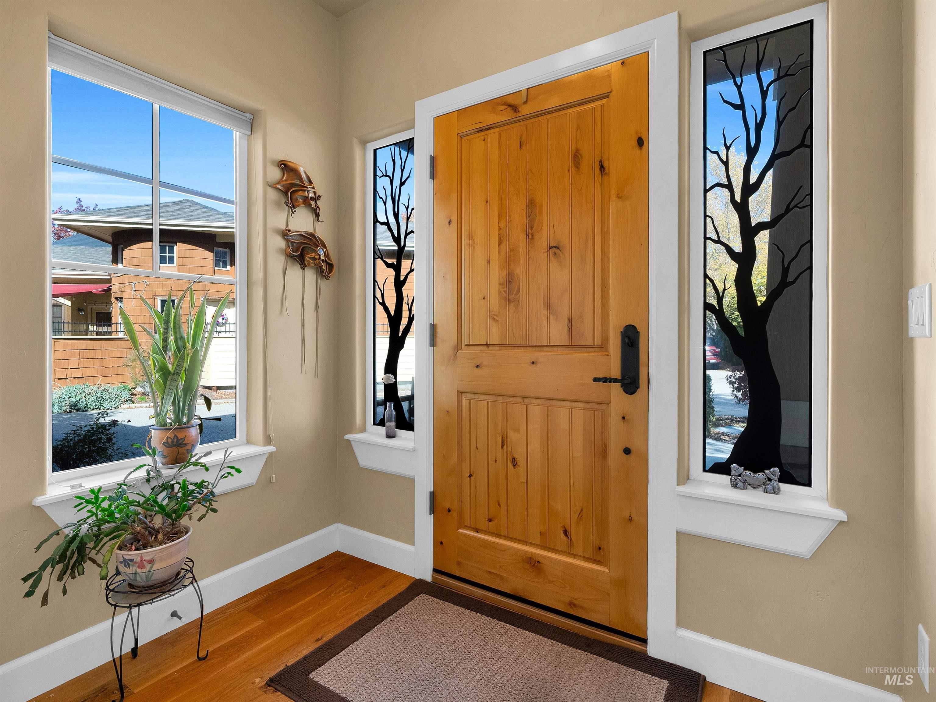 Foyer featuring baseboards and wood finished floors