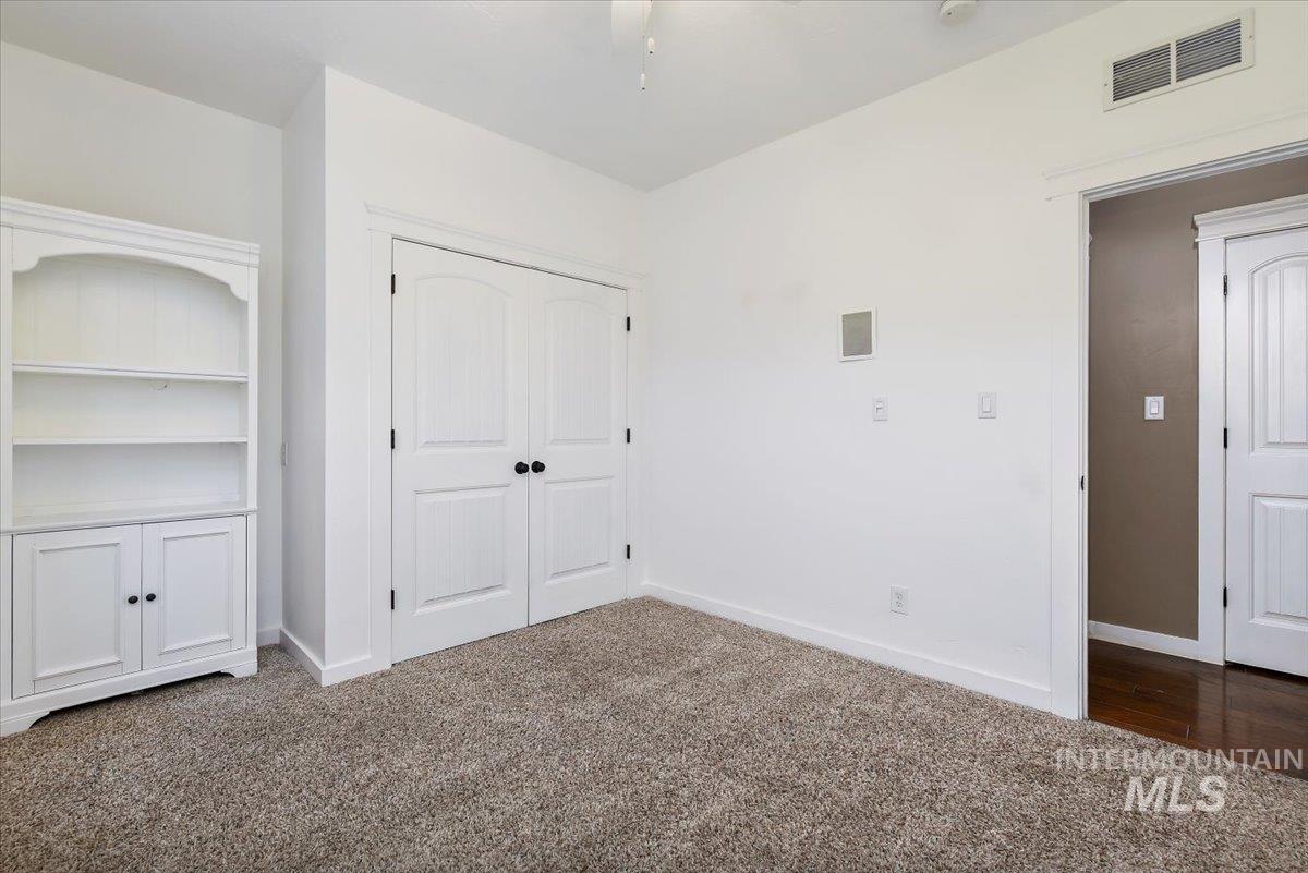 Unfurnished bedroom featuring carpet and a closet