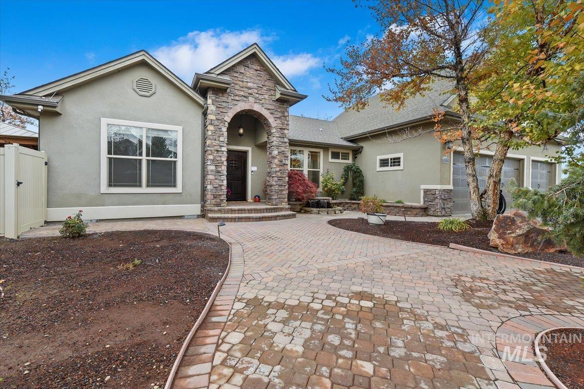 View of front of home featuring stucco siding and stone siding