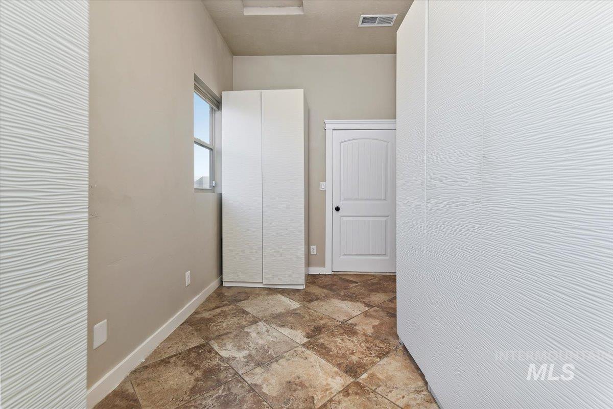 Large mudroom with tile floors and bathroom.