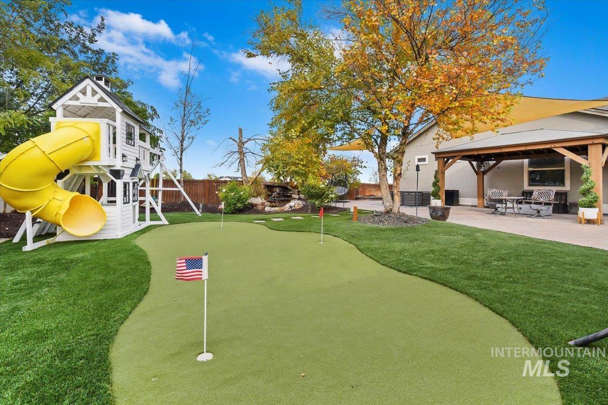 Enjoy your patio area, a fenced backyard, a putting area, a playground, and a gazebo