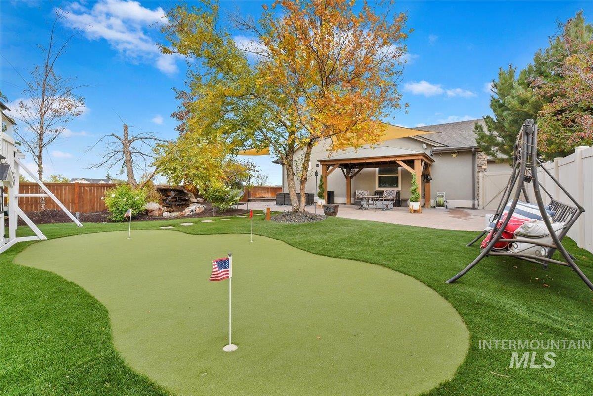 Featuring a patio area, a fenced backyard, and your own putting green