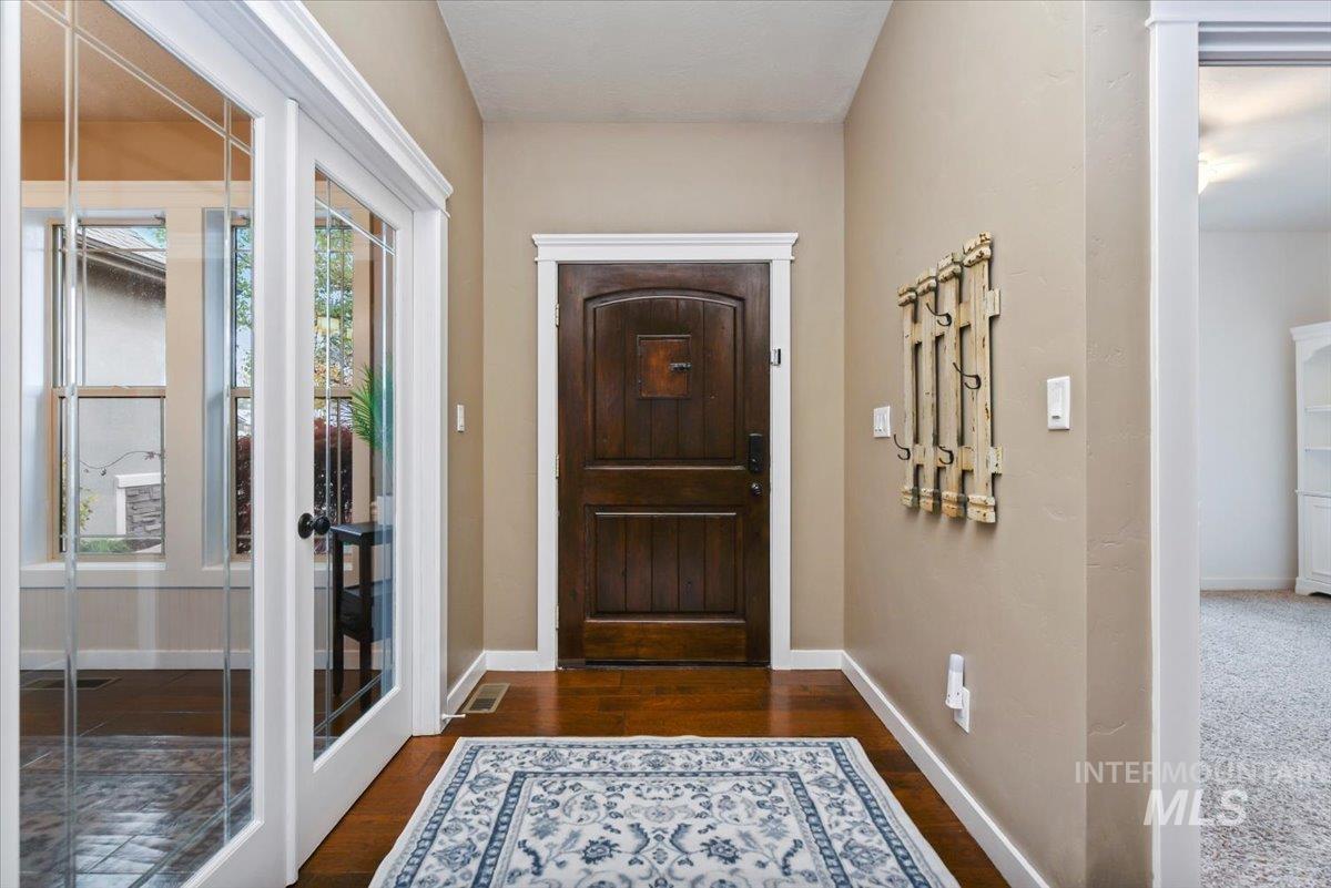 Entrance foyer featuring wood-style floors