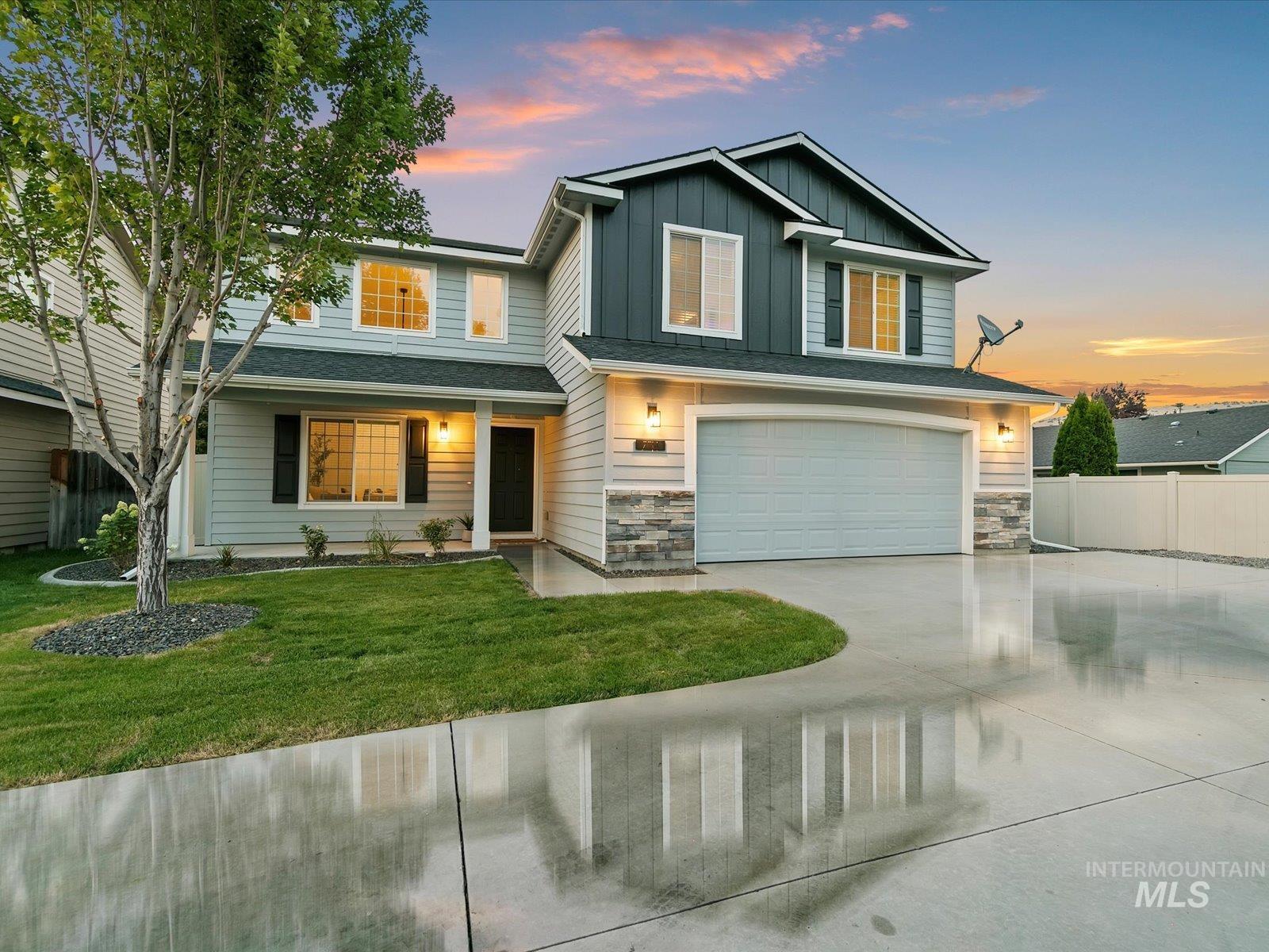 View of front facade featuring board and batten siding, concrete driveway, a garage, a porch, and stone siding