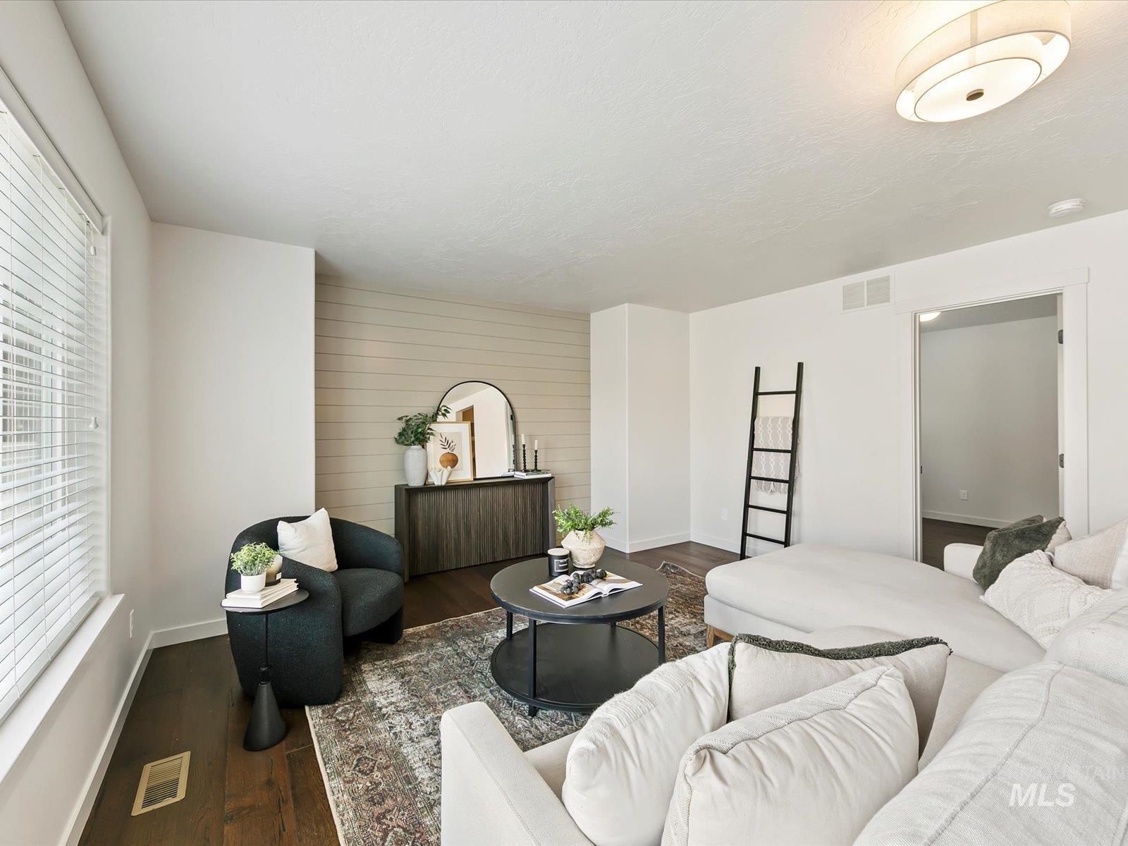 Living area with wood finished floors and baseboards