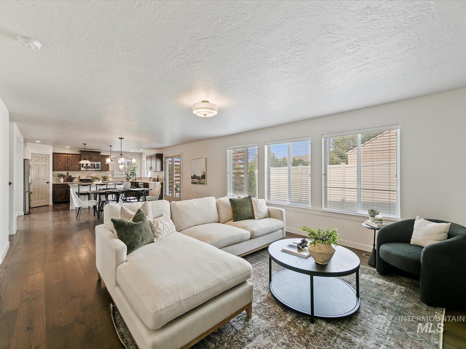 Living room featuring dark wood finished floors and a textured ceiling