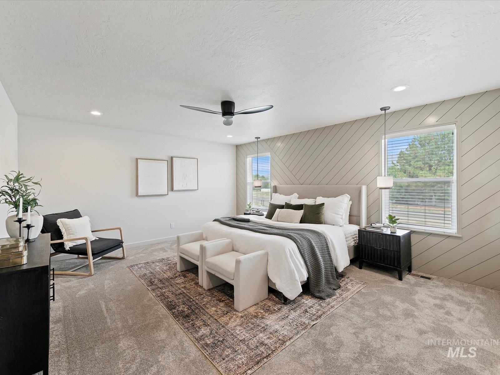 Carpeted bedroom featuring multiple windows, a textured ceiling, ceiling fan, recessed lighting, and wood walls