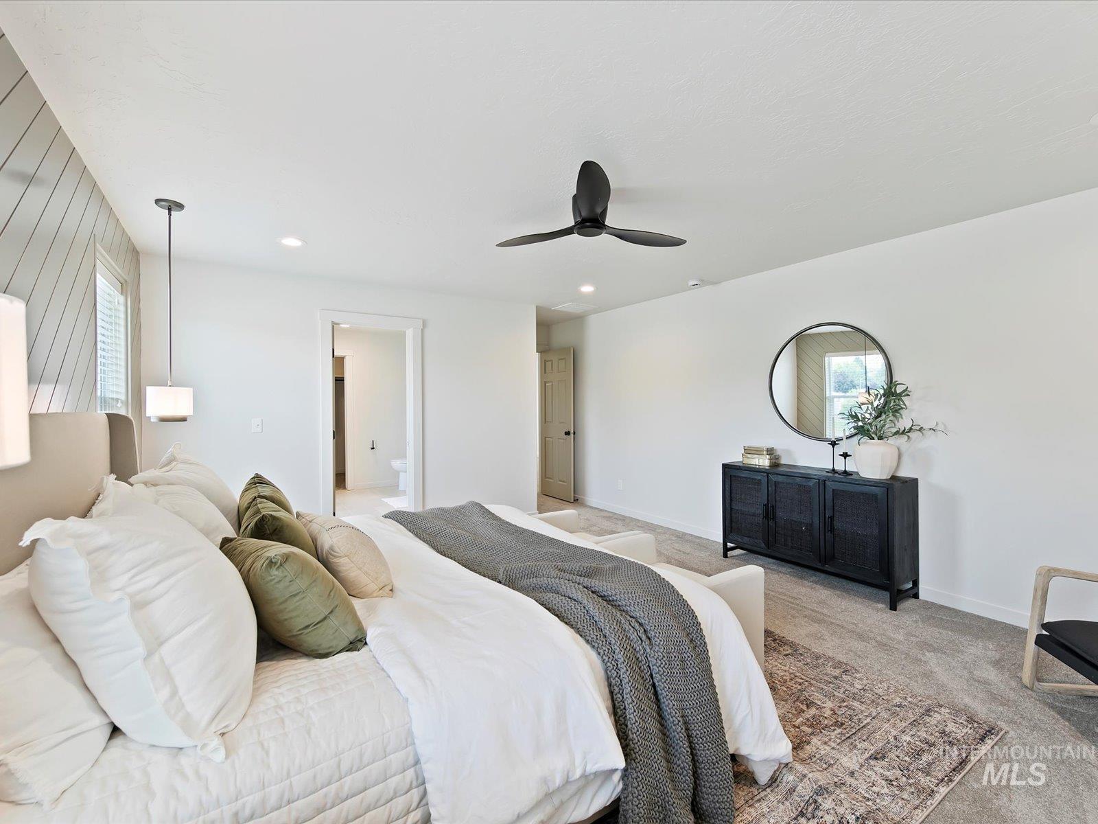 Carpeted bedroom featuring a ceiling fan and recessed lighting